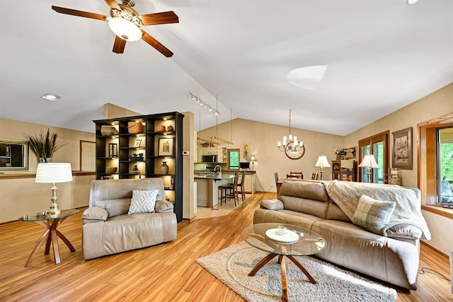 2511 S Natures Ridge Rd, Beloit, WI 53511 - living area with lofted ceiling, light wood-type flooring, a ceiling fan, and a chandelier