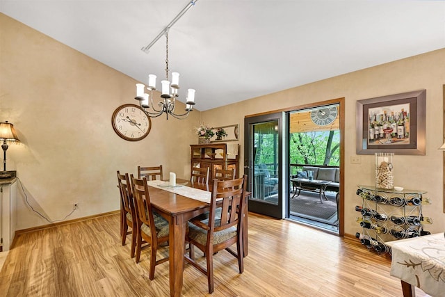 2511 S Natures Ridge Rd, Beloit, WI 53511 - dining space featuring light wood-style floors, a chandelier, track lighting, baseboards, and lofted ceiling