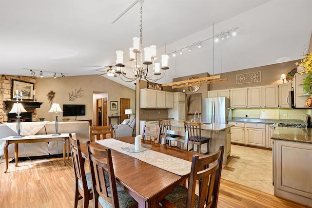 2511 S Natures Ridge Rd, Beloit, WI 53511 - dining space featuring track lighting, vaulted ceiling, a chandelier, ceiling fan, and light wood-style flooring