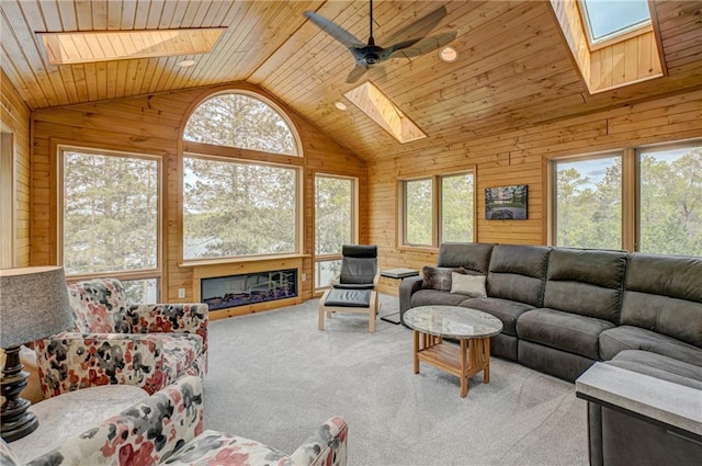 3844 State Road 77, Danbury, WI 54830 - living area featuring a skylight, vaulted ceiling, wooden walls, carpet floors, and wooden ceiling