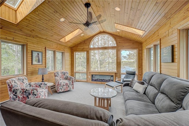 3844 State Road 77, Danbury, WI 54830 - carpeted living room featuring a skylight, wooden walls, healthy amount of natural light, lofted ceiling, and wooden ceiling
