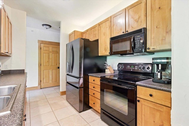 441 Clara Ave Unit 115, Wisconsin Dells, WI 53965 - kitchen with black appliances, dark countertops, light tile patterned floors, and a sink