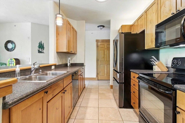 441 Clara Ave Unit 115, Wisconsin Dells, WI 53965 - kitchen featuring black appliances, dark countertops, a sink, and light tile patterned floors