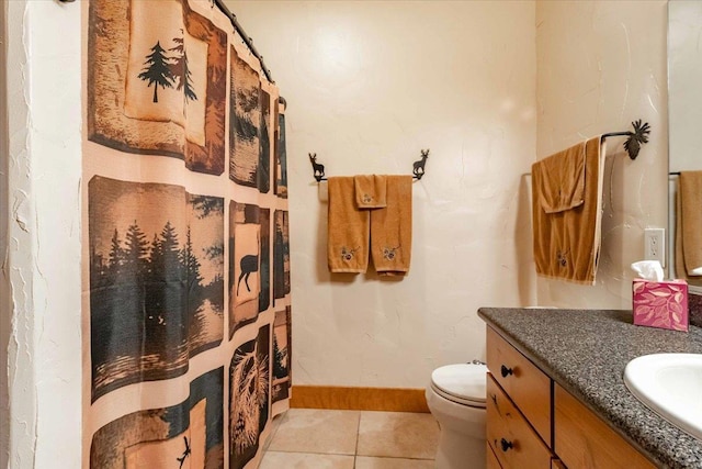 441 Clara Ave Unit 115, Wisconsin Dells, WI 53965 - bathroom with vanity, toilet, tile patterned floors, baseboards, and curtained shower