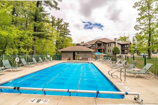 441 Clara Ave Unit 115, Wisconsin Dells, WI 53965 - community pool featuring a patio and view of wooded area