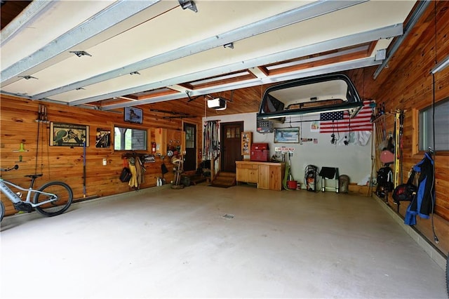 10435 W Murphy Blvd, Hayward, WI 54843 - garage featuring wood walls and a garage door opener