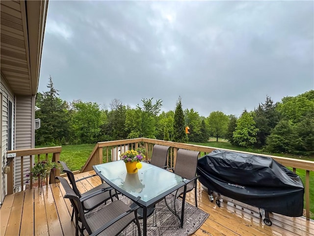 N1816 950th St, Eau Claire, WI 54701 - wooden deck with outdoor dining space, grilling area, and a view of trees