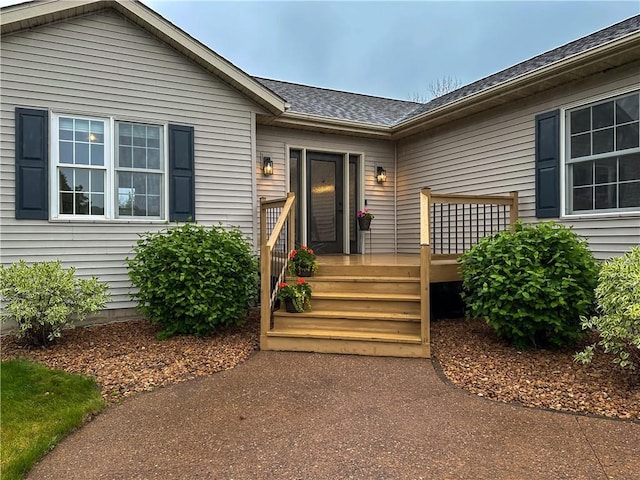 N1816 950th St, Eau Claire, WI 54701 - view of exterior entry featuring a deck and roof with shingles