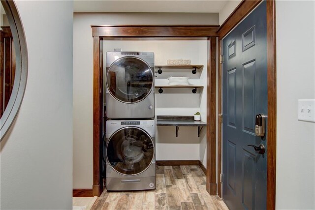 N1816 950th St, Eau Claire, WI 54701 - washroom with estacked washer and dryer, wood finished floors, and baseboards