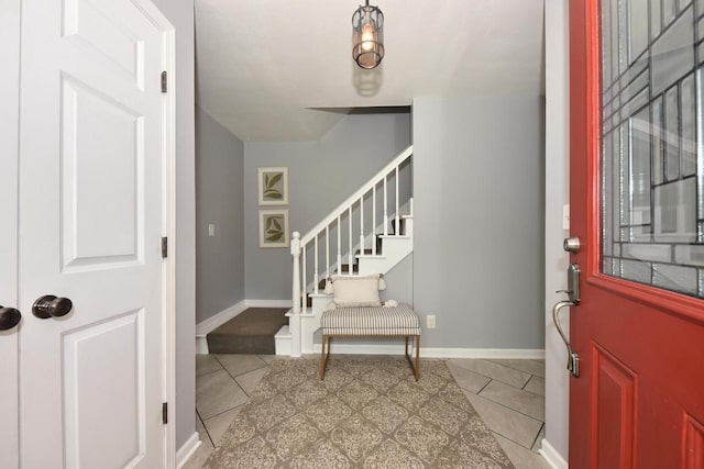 1429 W River Oaks Ln, Mequon, WI 53092 - tiled entrance foyer featuring stairway and baseboards