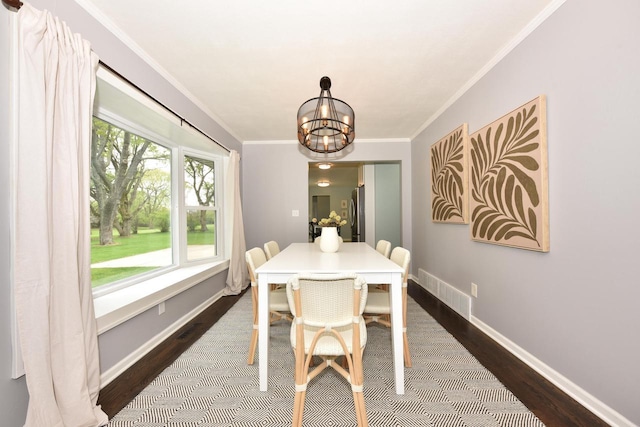 1429 W River Oaks Ln, Mequon, WI 53092 - dining space with dark wood-style flooring, a chandelier, baseboards, and ornamental molding