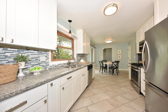 1429 W River Oaks Ln, Mequon, WI 53092 - kitchen with stainless steel appliances, a sink, decorative backsplash, and white cabinets