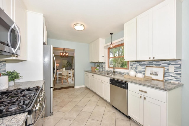 1429 W River Oaks Ln, Mequon, WI 53092 - kitchen with appliances with stainless steel finishes, a sink, decorative backsplash, and white cabinetry