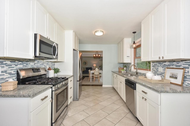 1429 W River Oaks Ln, Mequon, WI 53092 - kitchen with stainless steel appliances, a sink, decorative backsplash, and white cabinets