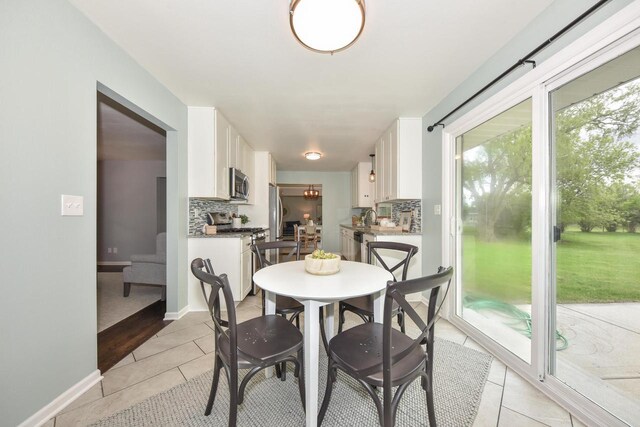 1429 W River Oaks Ln, Mequon, WI 53092 - dining area with light tile patterned flooring and baseboards