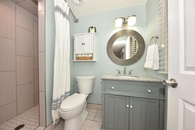 1429 W River Oaks Ln, Mequon, WI 53092 - bathroom with tiled shower, vanity, toilet, and tile patterned floors