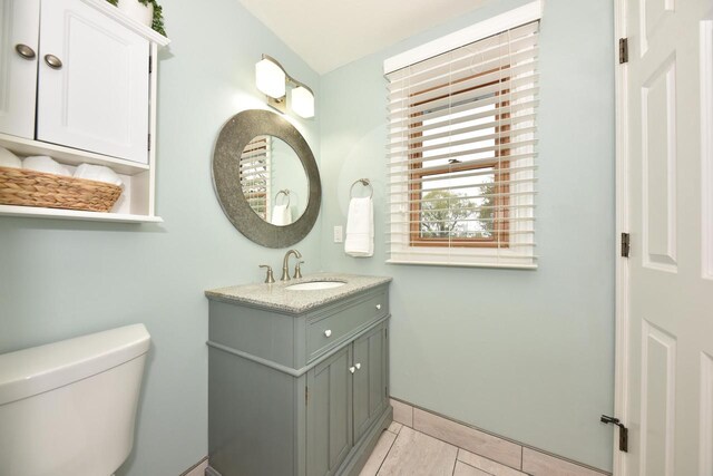 1429 W River Oaks Ln, Mequon, WI 53092 - bathroom featuring toilet, vanity, and tile patterned flooring