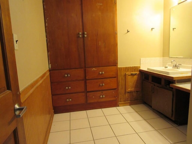 2022 N 20th St, Sheboygan, WI 53081 - bathroom with wainscoting, vanity, wooden walls, and tile patterned floors