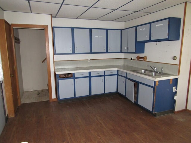 2022 N 20th St, Sheboygan, WI 53081 - kitchen with dark wood-type flooring, a sink, light countertops, and blue cabinetry
