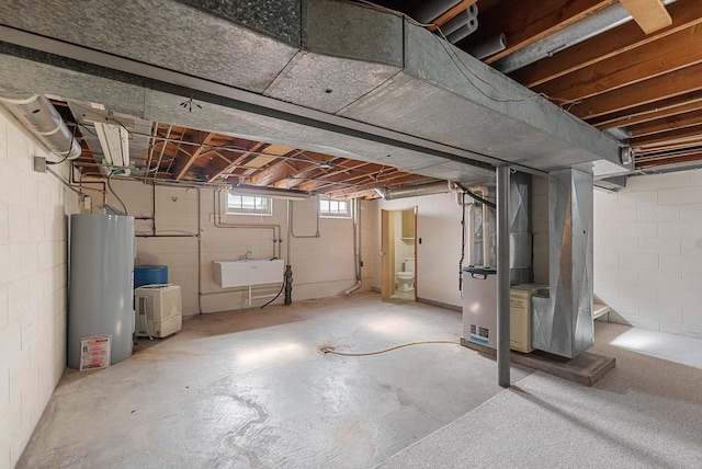 2109 Salisbury Rd, West Bend, WI 53090 - basement with gas water heater, a sink, and heating unit