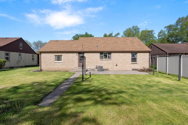 2109 Salisbury Rd, West Bend, WI 53090 - rear view of house featuring brick siding, a patio area, and central AC