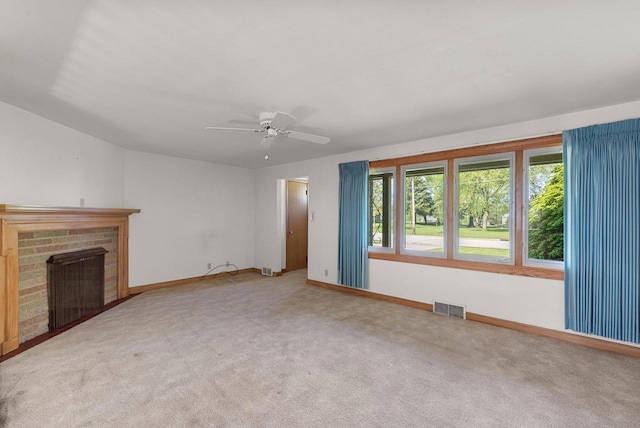 2109 Salisbury Rd, West Bend, WI 53090 - unfurnished living room with baseboards, carpet, a brick fireplace, and a ceiling fan