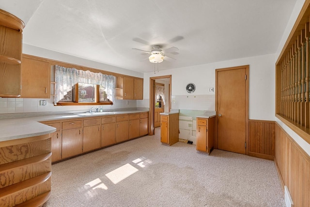 2109 Salisbury Rd, West Bend, WI 53090 - kitchen with open shelves, a sink, a ceiling fan, light countertops, and wainscoting