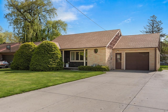 2109 Salisbury Rd, West Bend, WI 53090 - view of front facade featuring concrete driveway, a garage, brick siding, a front yard, and roof with shingles