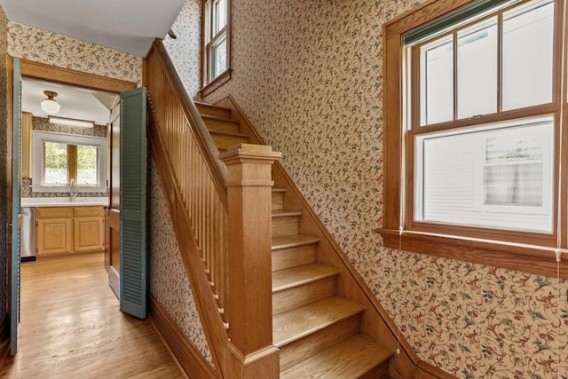 644 Crandall St, Madison, WI 53711 - staircase with wallpapered walls, wood finished floors, and baseboards