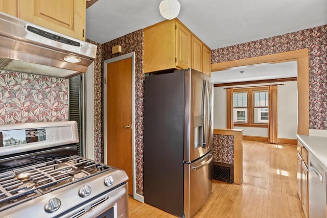 644 Crandall St, Madison, WI 53711 - kitchen with appliances with stainless steel finishes, range hood, wallpapered walls, light wood-style floors, and light brown cabinetry