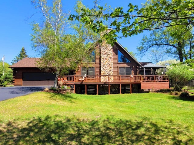 610 Fox Ridge Ct, Nekoosa, WI 54457 - rear view of house with log siding, a yard, and a wooden deck
