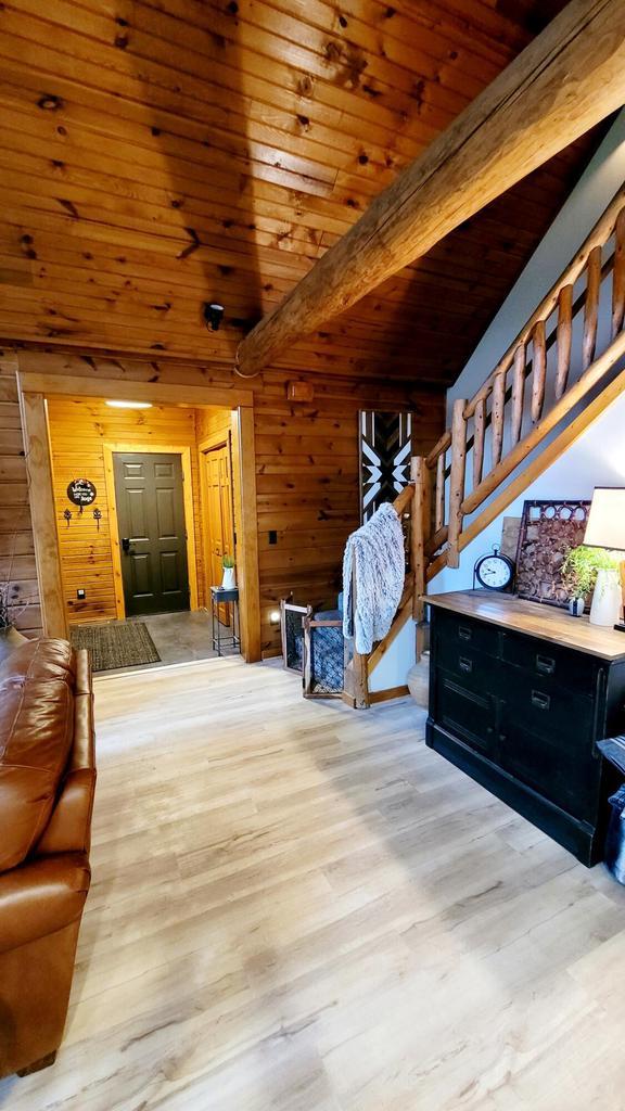 610 Fox Ridge Ct, Nekoosa, WI 54457 - bedroom featuring wood walls, wood finished floors, and a wooden ceiling with exposed beams