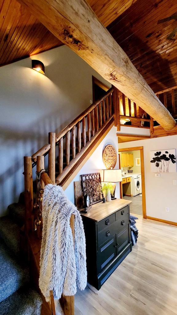 610 Fox Ridge Ct, Nekoosa, WI 54457 - living room with separate washer and dryer, wood ceiling, stairs, and light wood-type flooring