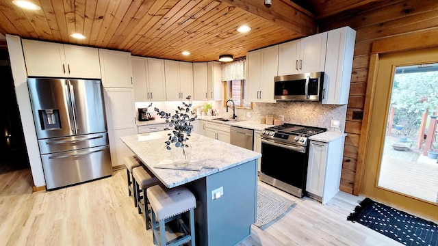 610 Fox Ridge Ct, Nekoosa, WI 54457 - kitchen with stainless steel appliances, wood ceiling, light wood-style flooring, light stone countertops, and backsplash