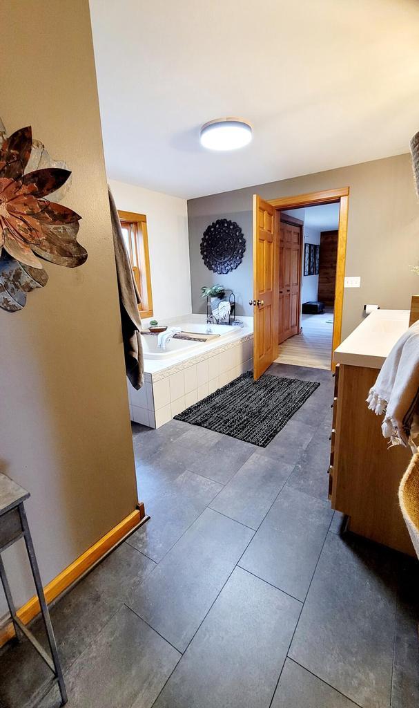 610 Fox Ridge Ct, Nekoosa, WI 54457 - full bathroom with vanity, a bath, and tile patterned flooring
