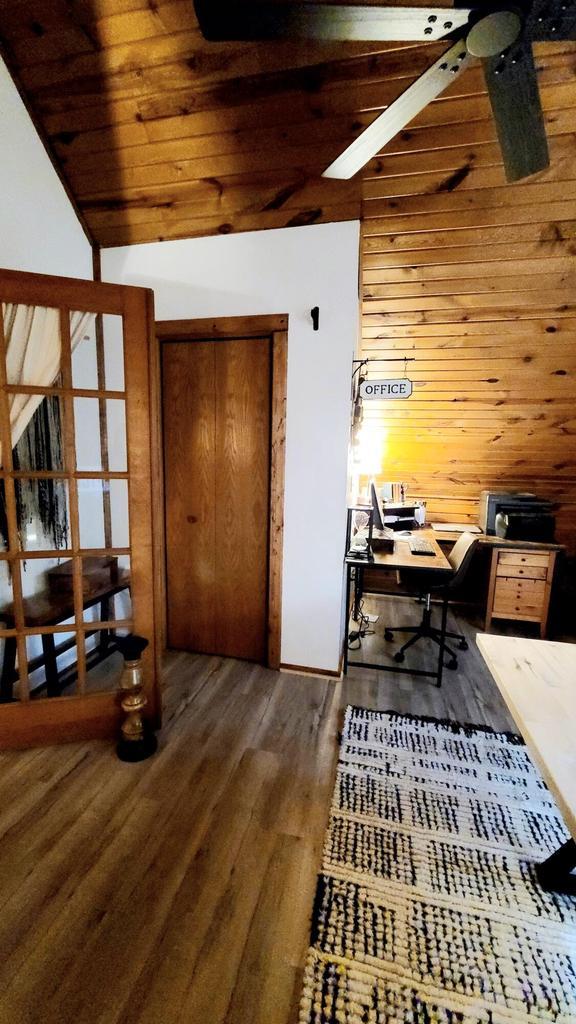 610 Fox Ridge Ct, Nekoosa, WI 54457 - home office featuring ceiling fan, wood finished floors, wood walls, lofted ceiling, and wooden ceiling