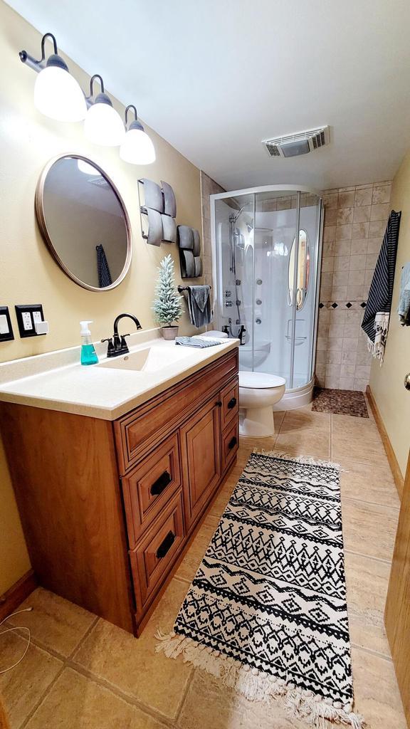 610 Fox Ridge Ct, Nekoosa, WI 54457 - full bath with vanity, a stall shower, and tile patterned floors