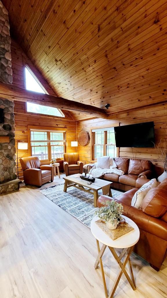 610 Fox Ridge Ct, Nekoosa, WI 54457 - living room featuring healthy amount of natural light, wood walls, high vaulted ceiling, light wood-style floors, and wooden ceiling