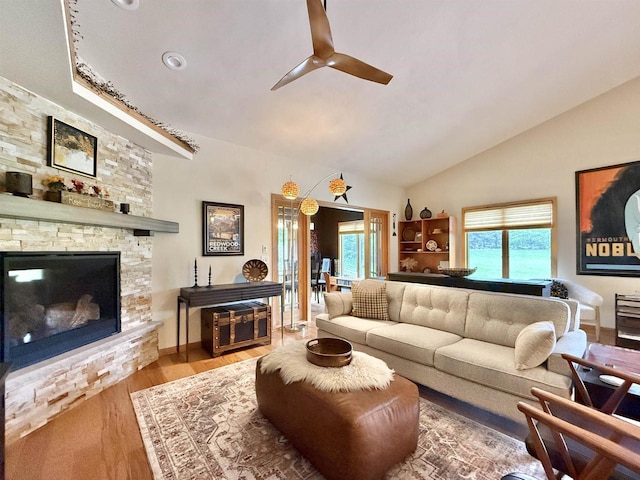 2728 E Ridge Rd, Beloit, WI 53511 - living room with ceiling fan, wood finished floors, a stone fireplace, and high vaulted ceiling