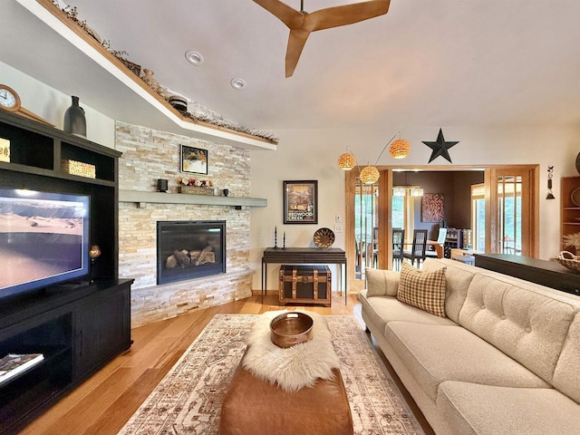 2728 E Ridge Rd, Beloit, WI 53511 - living area featuring wood finished floors, a ceiling fan, and a stone fireplace
