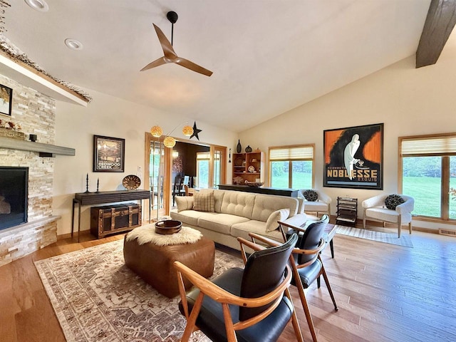 2728 E Ridge Rd, Beloit, WI 53511 - living room featuring wood finished floors, a ceiling fan, a stone fireplace, high vaulted ceiling, and recessed lighting