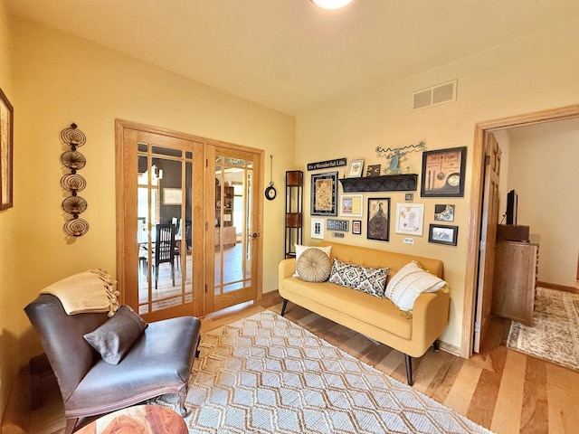 2728 E Ridge Rd, Beloit, WI 53511 - living room featuring french doors, wood finished floors, and baseboards