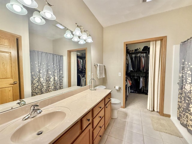2728 E Ridge Rd, Beloit, WI 53511 - full bath featuring a spacious closet, vanity, tile patterned flooring, toilet, and a shower with curtain