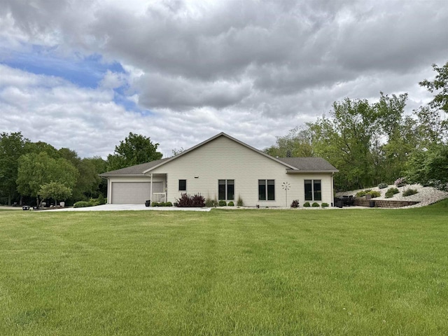 2728 E Ridge Rd, Beloit, WI 53511 - back of property with a garage, driveway, and a lawn