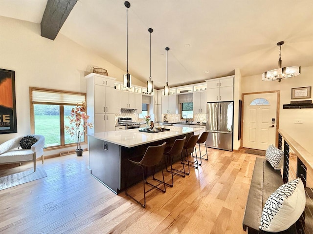 2728 E Ridge Rd, Beloit, WI 53511 - kitchen with appliances with stainless steel finishes, a sink, light wood-type flooring, and white cabinets