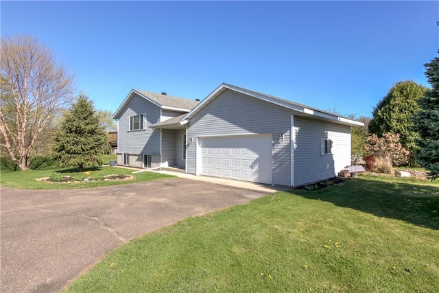 N4907 572nd St, Menomonie, WI 54751 - view of front facade with a garage, a front yard, and driveway