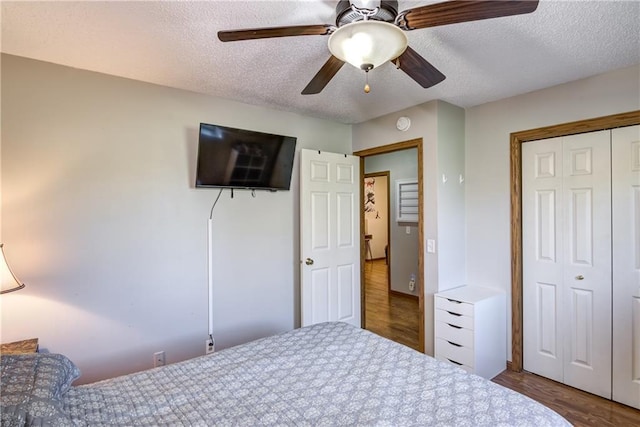 N4907 572nd St, Menomonie, WI 54751 - bedroom featuring wood finished floors, a textured ceiling, a closet, and ceiling fan