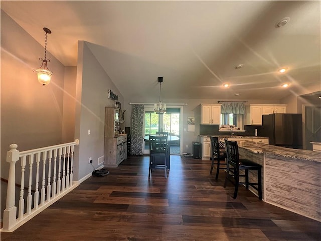 N2673 464th St, Menomonie, WI 54751 - kitchen featuring freestanding refrigerator, white cabinetry, vaulted ceiling, dark wood-type flooring, and recessed lighting