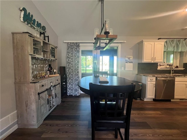 N2673 464th St, Menomonie, WI 54751 - dining space with dark wood-style flooring, vaulted ceiling, and baseboards