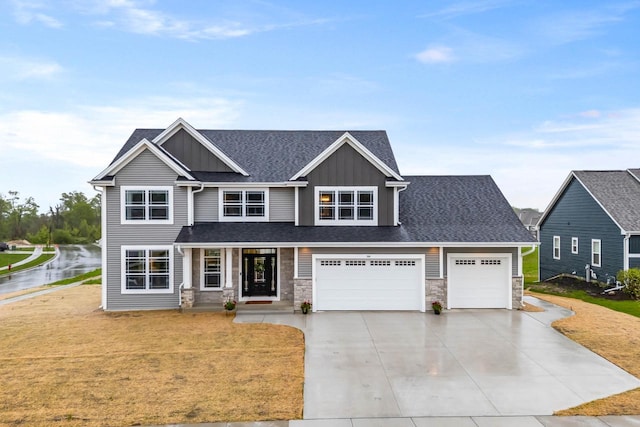 788 Kohlwey Dr, Grafton, WI 53024 - craftsman inspired home featuring concrete driveway, board and batten siding, a front lawn, and stone siding